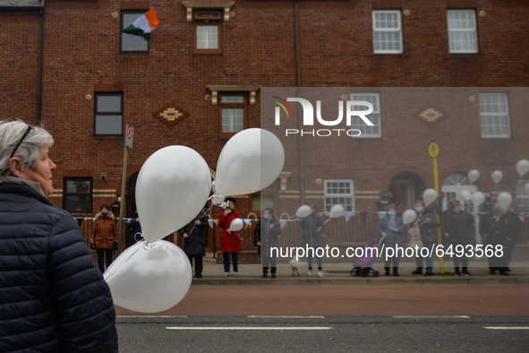 Residents of New Street in Dublin hold white balloons to say goodbye to their recently departed neighbour, Mrs. Quinn (age 89). 
Since the b...