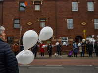 Residents of New Street in Dublin hold white balloons to say goodbye to their recently departed neighbour, Mrs. Quinn (age 89). 
Since the b...