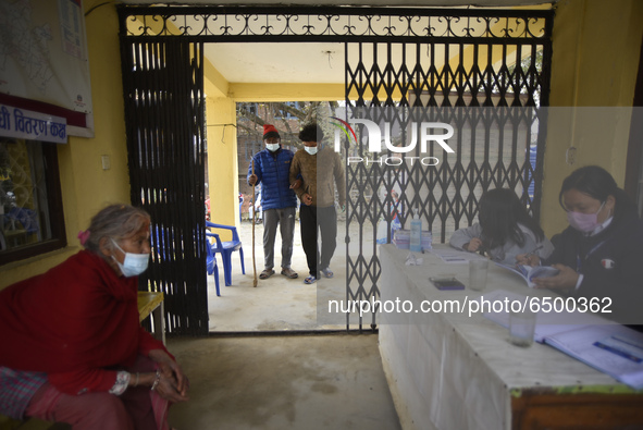 A family member helps to bring Nepalese People above 65 to get first dose of COVID19 vaccines developed by Oxford- AstraZeneca Plc at Bal Ku...