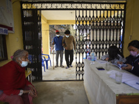 A family member helps to bring Nepalese People above 65 to get first dose of COVID19 vaccines developed by Oxford- AstraZeneca Plc at Bal Ku...