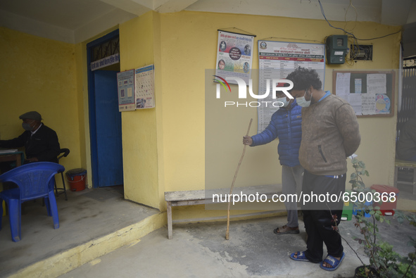 A family member helps to bring Nepalese People above 65 to get first dose of COVID19 vaccines developed by Oxford- AstraZeneca Plc at Bal Ku...