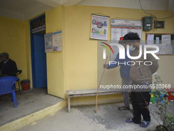 A family member helps to bring Nepalese People above 65 to get first dose of COVID19 vaccines developed by Oxford- AstraZeneca Plc at Bal Ku...