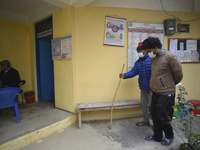 A family member helps to bring Nepalese People above 65 to get first dose of COVID19 vaccines developed by Oxford- AstraZeneca Plc at Bal Ku...