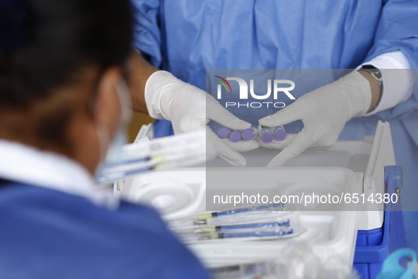 A nurse prepares a dose of Pfizer-BioNTech Covid-19 vaccine before inject to an elderly, during mass vaccine inside of Hermanos Lopez Rayon...