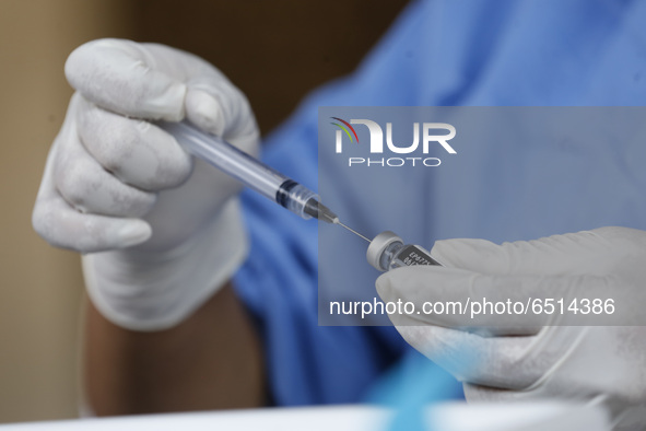 A nurse prepares a dose of Pfizer-BioNTech Covid-19 vaccine before inject to an elderly, during mass vaccine inside of Hermanos Lopez Rayon...