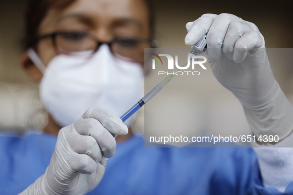 A nurse prepares a dose of Pfizer-BioNTech Covid-19 vaccine before inject to an elderly, during mass vaccine inside of Hermanos Lopez Rayon...