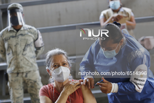 A person receives a dose of Pfizer-BioNTech Covid-19 vaccine before inject to an elderly, during mass vaccine inside of Hermanos Lopez Rayon...