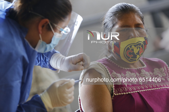 A person receives a dose of Pfizer-BioNTech Covid-19 vaccine before inject to an elderly, during mass vaccine inside of Hermanos Lopez Rayon...