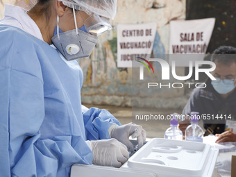 A nurse prepares a dose of Pfizer-BioNTech Covid-19 vaccine before inject to an elderly, during mass vaccine inside of Hermanos Lopez Rayon...