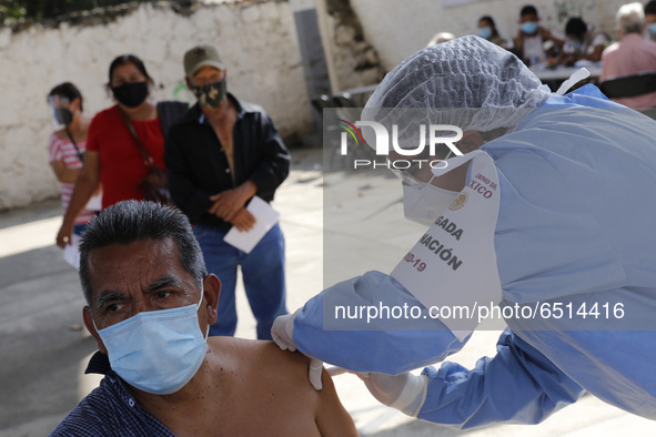 A person receives a dose of Pfizer-BioNTech Covid-19 vaccine before inject to an elderly, during mass vaccine inside of Hermanos Lopez Rayon...