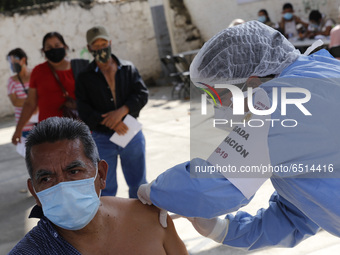 A person receives a dose of Pfizer-BioNTech Covid-19 vaccine before inject to an elderly, during mass vaccine inside of Hermanos Lopez Rayon...