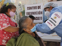 A person receives a dose of Pfizer-BioNTech Covid-19 vaccine before inject to an elderly, during mass vaccine inside of Hermanos Lopez Rayon...