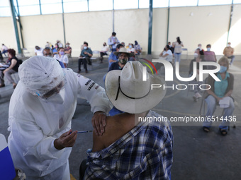 A person receives a dose of Pfizer-BioNTech Covid-19 vaccine before inject to an elderly, during mass vaccine inside of Hermanos Lopez Rayon...