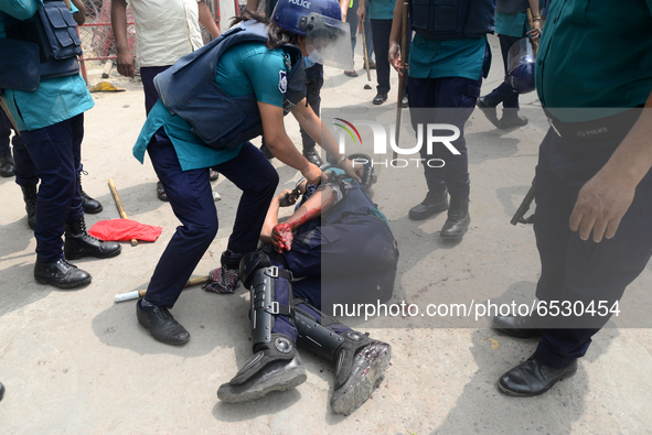 A Policeman injured during clashes between garment workers and police in Dhaka, Bangladesh, on March 16, 2021. Garments workers of Stitch We...