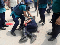 A Policeman injured during clashes between garment workers and police in Dhaka, Bangladesh, on March 16, 2021. Garments workers of Stitch We...