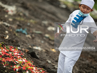 A child cried in front of his grandma grave. Burrial process of a victim of Covid19 at Srengsawah, South Jakarta, Indonesia on March 19, 202...