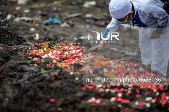 Las good bye from a child to his grandmother. Burrial process of a victim of Covid19 at Srengsawah, South Jakarta, Indonesia on March 19, 20...