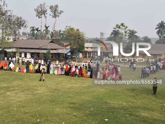 oters wait in queue to cast their ballots at a polling station during Phase 1 of Assam's legislative election in Nagaon district, in the nor...