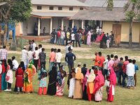 oters wait in queue to cast their ballots at a polling station during Phase 1 of Assam's legislative election in Nagaon district, in the nor...