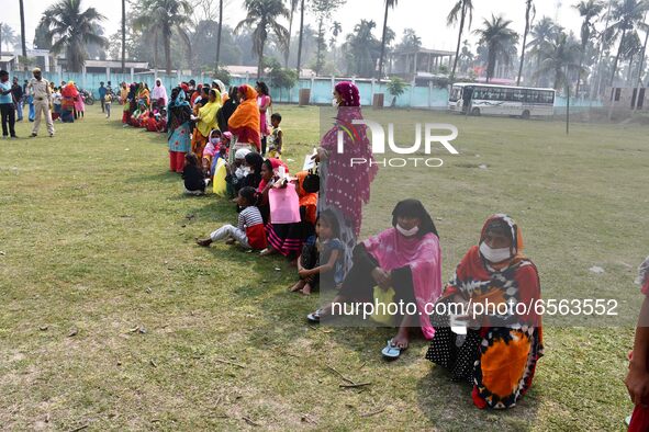 oters wait in queue to cast their ballots at a polling station during Phase 1 of Assam's legislative election in Nagaon district, in the nor...