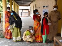 oters wait in queue to cast their ballots at a polling station during Phase 1 of Assam's legislative election in Nagaon district, in the nor...