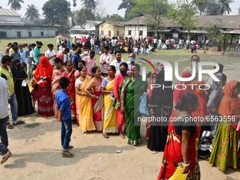 oters wait in queue to cast their ballots at a polling station during Phase 1 of Assam's legislative election in Nagaon district, in the nor...