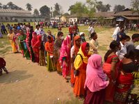 oters wait in queue to cast their ballots at a polling station during Phase 1 of Assam's legislative election in Nagaon district, in the nor...