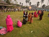 oters wait in queue to cast their ballots at a polling station during Phase 1 of Assam's legislative election in Nagaon district, in the nor...