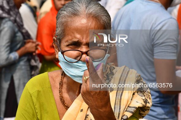 Woman voters hold up inked fingers after casting ballot  in the first  phase of polling for Assam Assembly Elections, at  Rupohi   constitue...