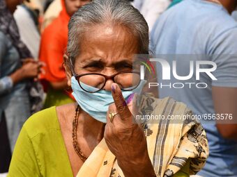 Woman voters hold up inked fingers after casting ballot  in the first  phase of polling for Assam Assembly Elections, at  Rupohi   constitue...