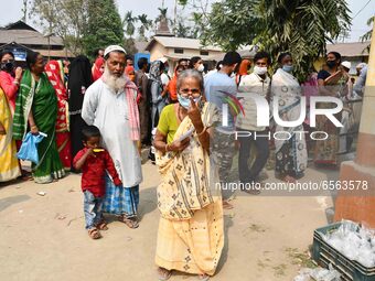 Woman voters hold up inked fingers after casting ballot  in the first  phase of polling for Assam Assembly Elections, at  Rupohi   constitue...