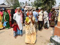 Woman voters hold up inked fingers after casting ballot  in the first  phase of polling for Assam Assembly Elections, at  Rupohi   constitue...