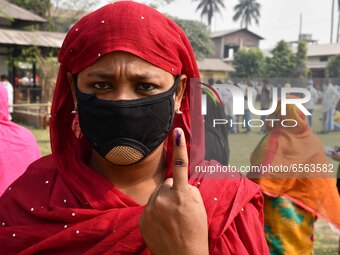 Woman voters hold up inked fingers after casting ballot  in the first  phase of polling for Assam Assembly Elections, at  Rupohi   constitue...