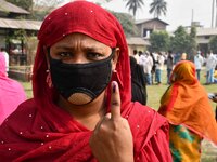 Woman voters hold up inked fingers after casting ballot  in the first  phase of polling for Assam Assembly Elections, at  Rupohi   constitue...