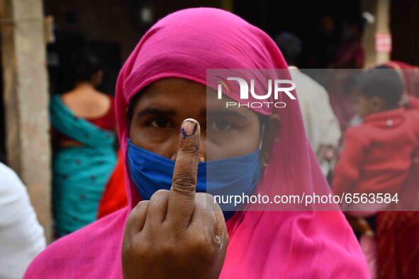 Woman voters hold up inked fingers after casting ballot  in the first  phase of polling for Assam Assembly Elections, at  Rupohi   constitue...