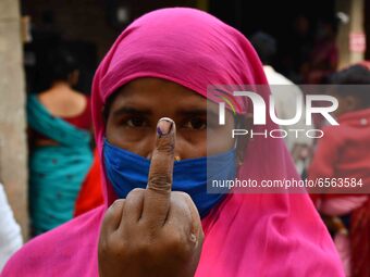 Woman voters hold up inked fingers after casting ballot  in the first  phase of polling for Assam Assembly Elections, at  Rupohi   constitue...