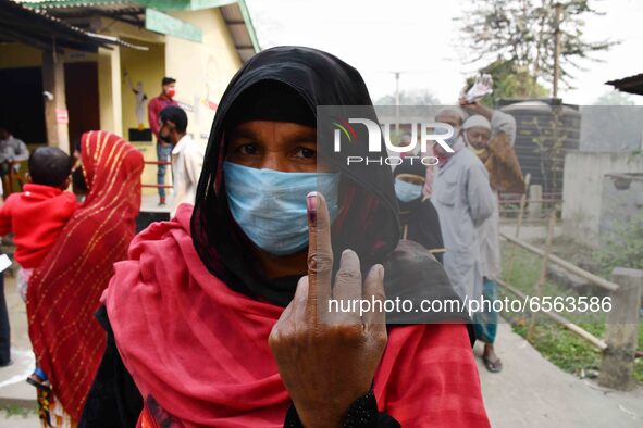 Woman voters hold up inked fingers after casting ballot  in the first  phase of polling for Assam Assembly Elections, at  Rupohi   constitue...