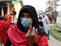 Woman voters hold up inked fingers after casting ballot  in the first  phase of polling for Assam Assembly Elections, at  Rupohi   constitue...