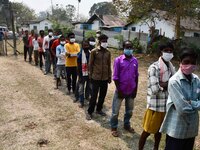 oters wait in queue to cast their ballots at a polling station during Phase 1 of Assam's legislative election in Nagaon district, in the nor...