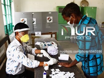 A voter's finger is inked while casting their ballot during first  phase polling  for Assam Assembly Elections, at Rupohi   constituency  in...