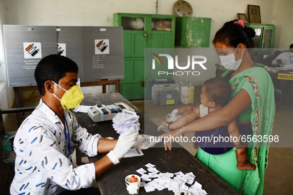 A voter's finger is inked while casting their ballot during first  phase polling  for Assam Assembly Elections, at Rupohi   constituency  in...