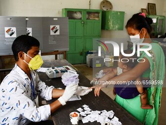 A voter's finger is inked while casting their ballot during first  phase polling  for Assam Assembly Elections, at Rupohi   constituency  in...