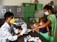 A voter's finger is inked while casting their ballot during first  phase polling  for Assam Assembly Elections, at Rupohi   constituency  in...