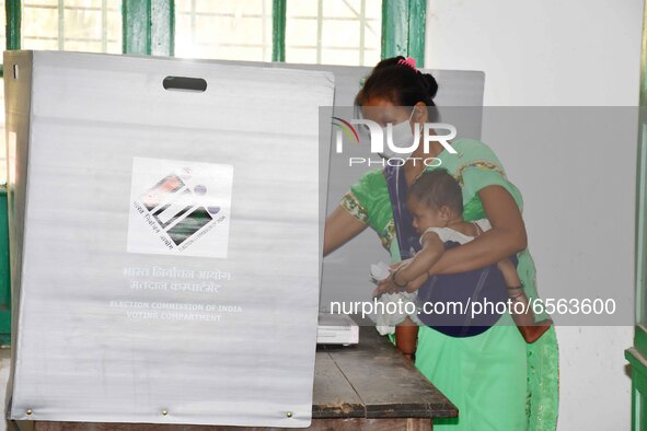 A  Women voters casting ballot  in the first  phase of polling for Assam Assembly Elections, at  Rupohi   constituency in Nagaon district, i...