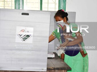 A  Women voters casting ballot  in the first  phase of polling for Assam Assembly Elections, at  Rupohi   constituency in Nagaon district, i...