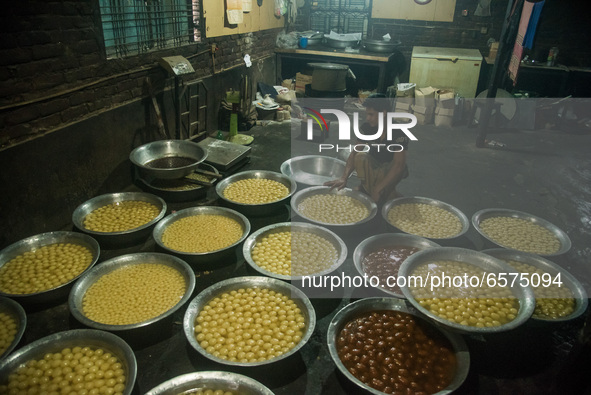 Labor is counting sweets after production at a traditional sweet production house in Bogura Bangladesh. 