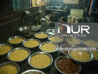 Labor is counting sweets after production at a traditional sweet production house in Bogura Bangladesh. (