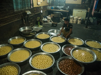 Labor is counting sweets after production at a traditional sweet production house in Bogura Bangladesh. (