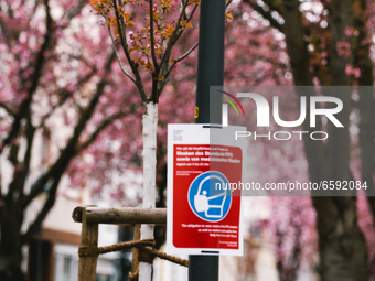 mask wearing sign is seen in the historical district in Bonn, Germany on April 04, 2021 (