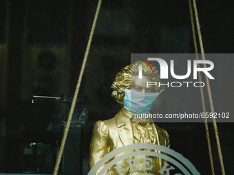 a statue of Beethoven with medical mask is seen on display in a shop in Bonn, Germany on April 4, 2021 (